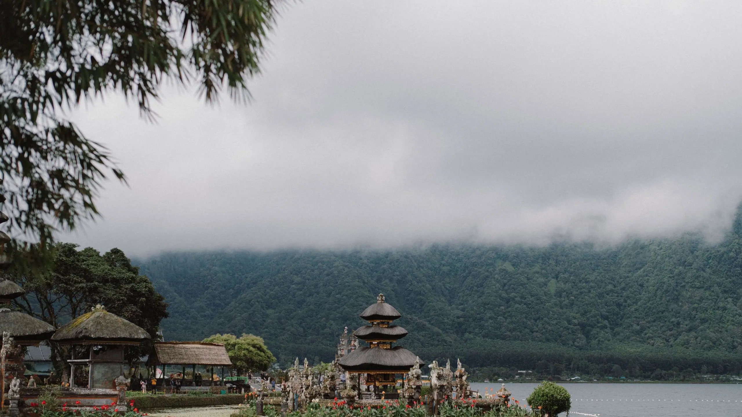 Lake Beratan in Bedugul under low morning cloud, with the Ulun Danu Beratan temple on the shore